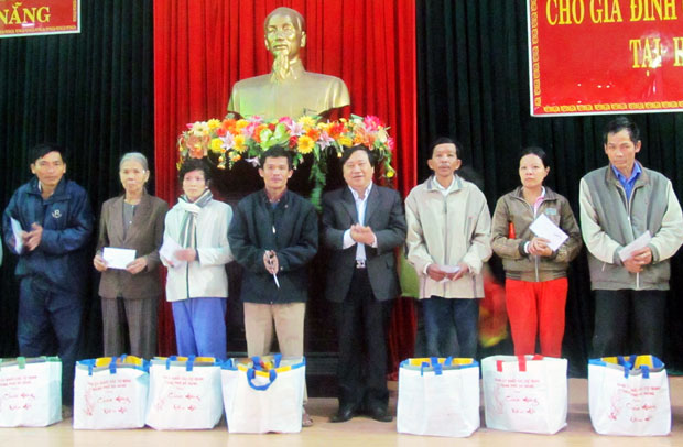 Bí thư Đảng ủy khối Các cơ quan thành phố Huỳnh Văn Hoa (giữa) trao quà cho các hộ đặc biệt nghèo ở Hòa Vang. 