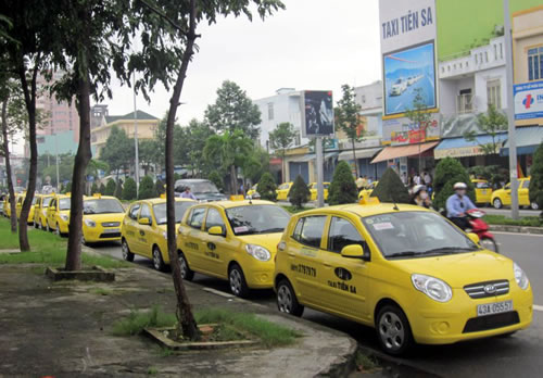 Tien Sa taxis parked on a local street 