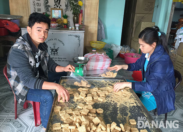 Huỳnh Đức Sol (bên trái) thuần thục làm bánh khô mè từ nhỏ để nay kế nghiệp gia đình.
