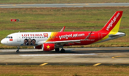 A VietJet Air airplane painted with Lotteria Viet Nam's logo taxis at Tan Son Nhat airport in Ho Chi Minh City.