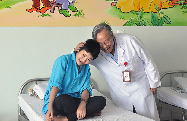 Giám đốc Bệnh viện Ung thư Đà Nẵng - Chủ tịch Hội Ung thư Đà Nẵng cùng với bệnh nhân nhi ung thư. (ảnh do bệnh viện cung cấp)