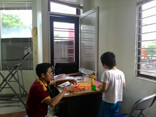 Nguyen Viet Van (left) and an autistic boy