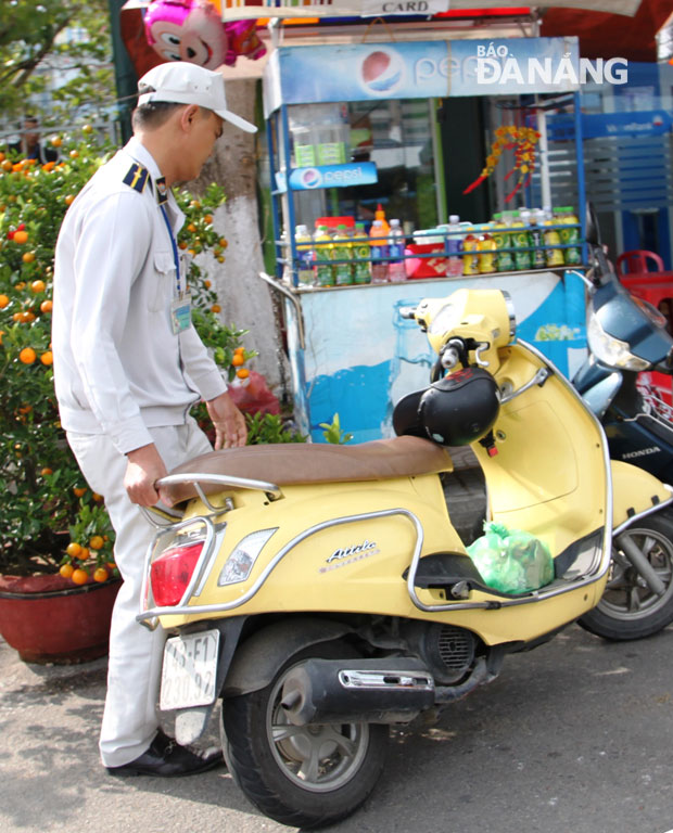 Lực lượng kiểm tra quy tắc đô thị sắp xếp gọn xe máy khóa cổ của khách đỗ dưới lòng đường