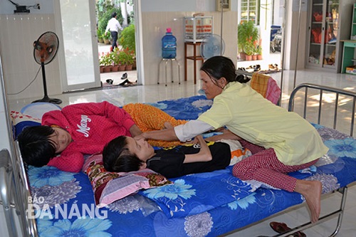  Mother May (right) taking care of her children Trinh and Truc