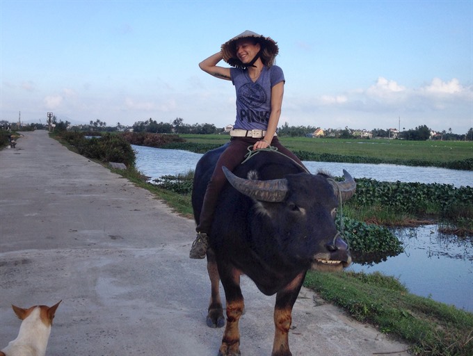 Getting there: Riding a buffalo in Việt Nam’s Hội An City was among Wick’s great experiences. Photos courtesy of Anemi Wick Read more at http://vietnamnews.vn/life-style/395023/swiss-writer-falls-in-love-with-the-back-streets.html#h60JkmgrtbPUyxk5.99