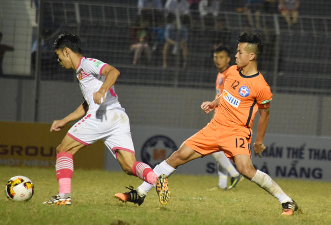 Hoàng Minh Tâm (áo cam) là cầu thủ người Đà Nẵng duy nhất được ra sân từ đầu trong trận đấu với Sài gòn FC (áo trắng). 		  Ảnh: VIẾT ĐỊNH