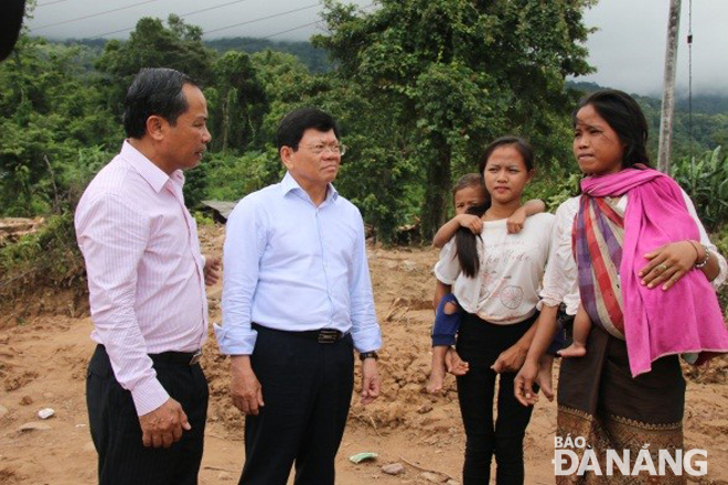 Deputy Secretary Tri (2nd, left) meeting with some affected residents in Attapeu Province