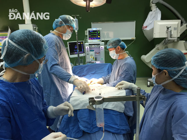 Doctors from the Da Nang General Hospital transplanting stem cells into the spine of a local patient with spinal cord injuries