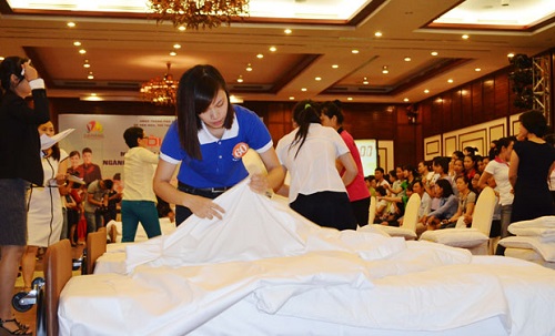 A contestant demonstrating her bed-making skills