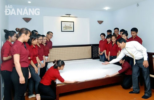 Local students practising bed-making at a local hotel