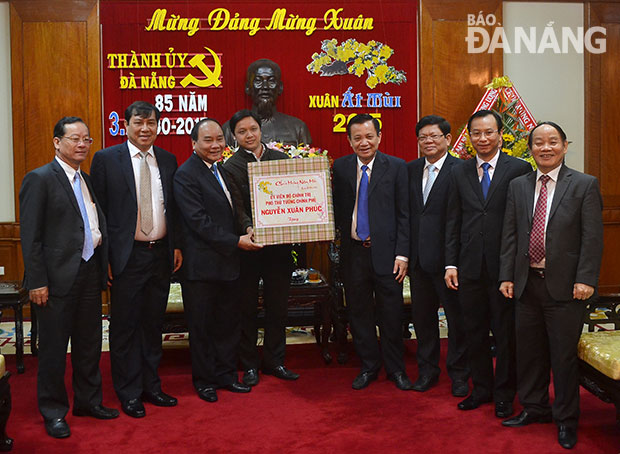 Phó Thủ tướng Chính phủ Nguyễn Xuân Phúc tặng quà Tết cho lãnh đạo thành phố Đà Nẵng.  Ảnh: VĂN NỞ