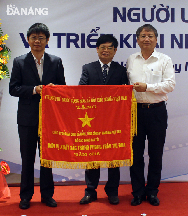 Thừa ủy quyền của Thủ tướng Chính phủ, Phó Chủ tịch UBND thành phố Nguyễn Ngọc Tuấn trao Cờ thi đua xuất sắc cho lãnh đạo cảng Đà Nẵng.          