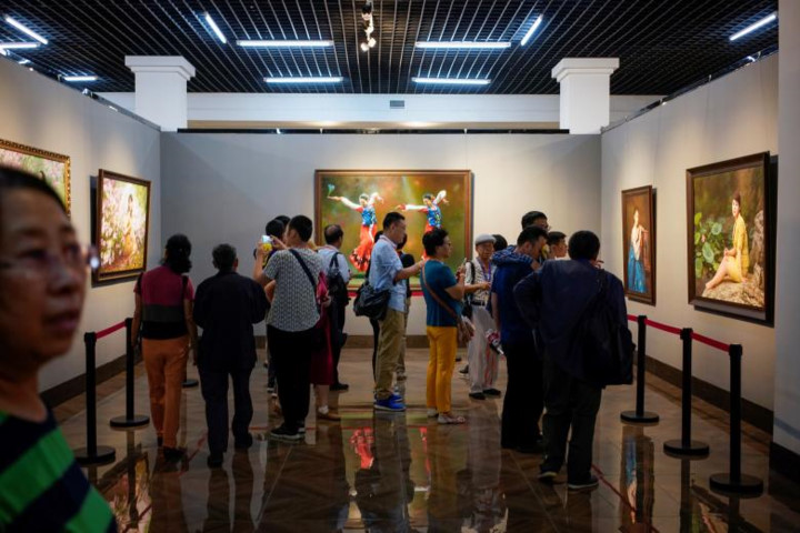 Người dân Trung Quốc tập trung ngắm những bức tranh do các nghệ sĩ Triều Tiên vẽ tại Trung tâm Nghệ thuật Trung-Triều tại Đan Đông, Liêu Ninh.