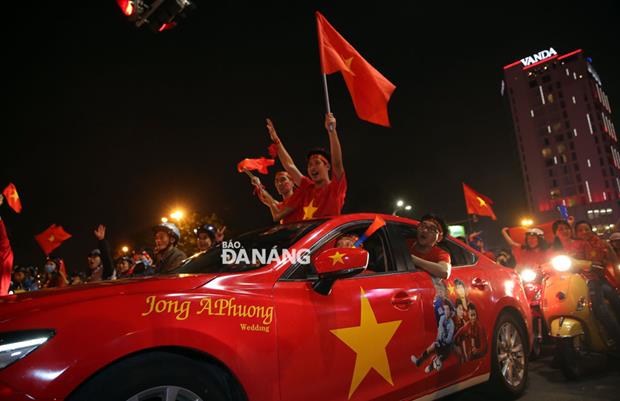 Huge numbers of revelers basking in the Vietnamese team’s dramatic victory on motorbikes, even on cars