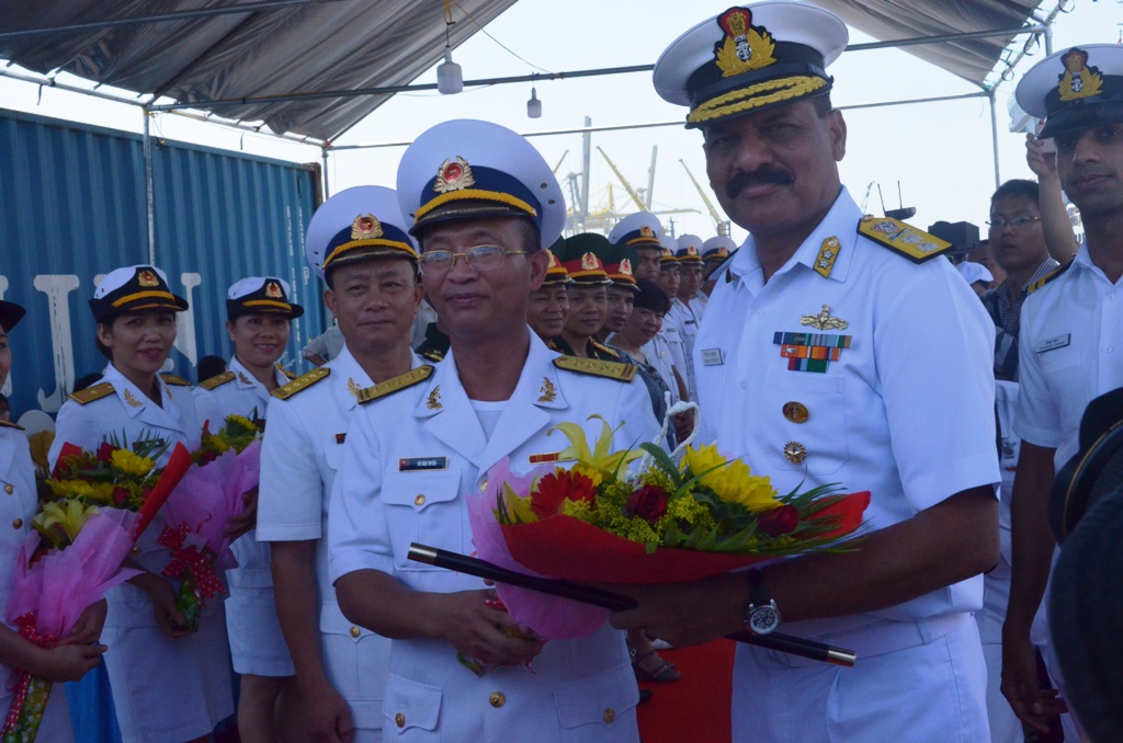 A representative from the High Command of Naval Zone 3 presenting flowers to Rear Admiral Dinesh K Tripathi (right)  