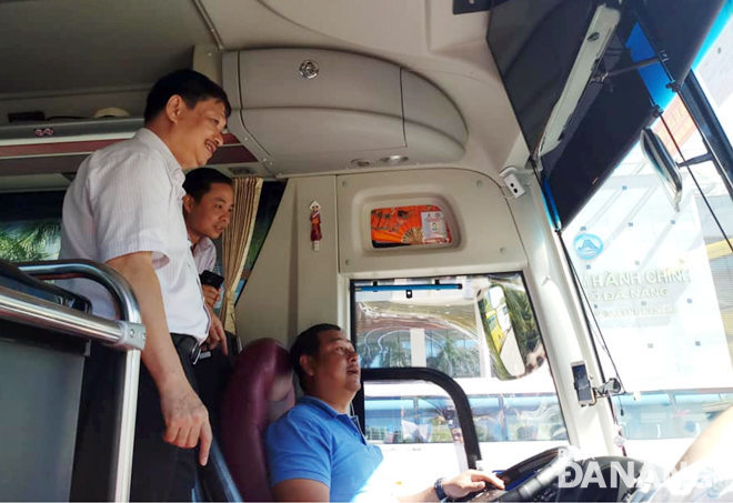 Vice Chairman Dung (left) checking surveillance cameras installed in a tourist coach