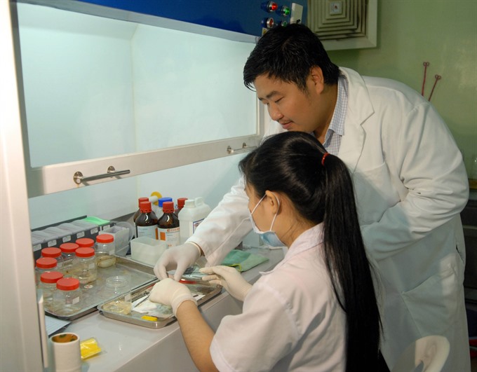 Scientists conduct researches on vaccine in an institute in HCM City