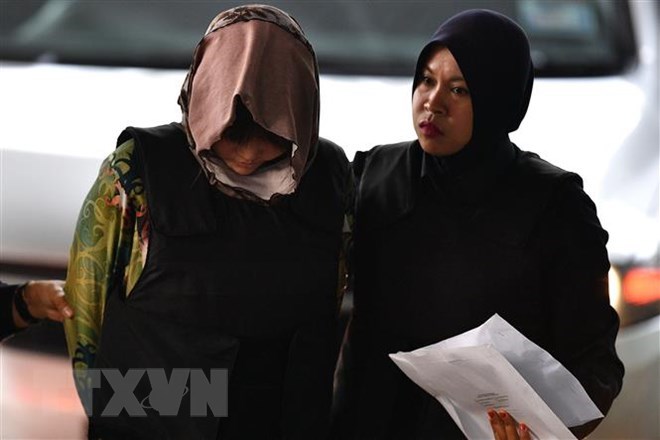 Doan Thi Huong, escorted by Malaysian police, in August (Photo: AFP/VNA)