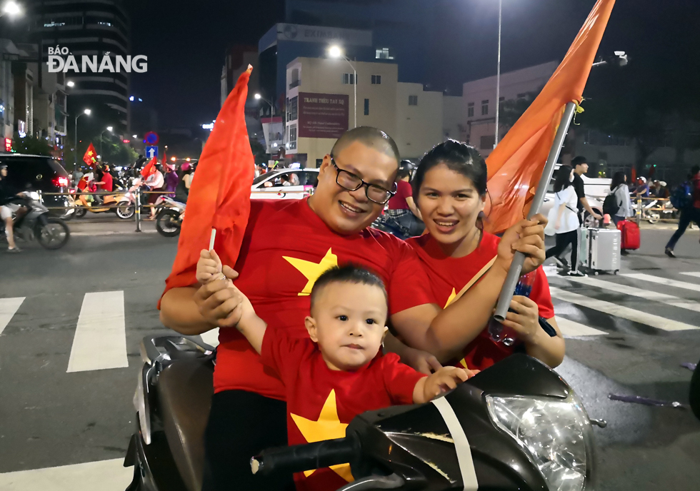 A little boy with their parents joining the street celebrations.