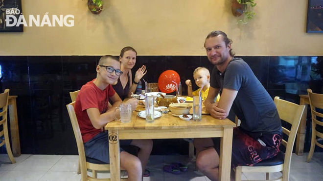 A family of foreigners enjoying meals at the Ton Nu Quan Restaurant.