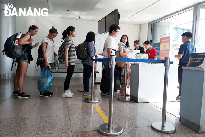 Passengers completing boarding procedures at the Da Nang International Airport