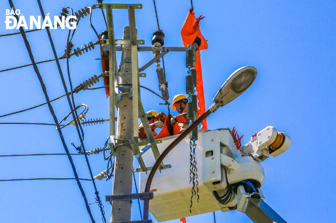 Workers carrying out maintenance work on high voltage power lines during hot summer days