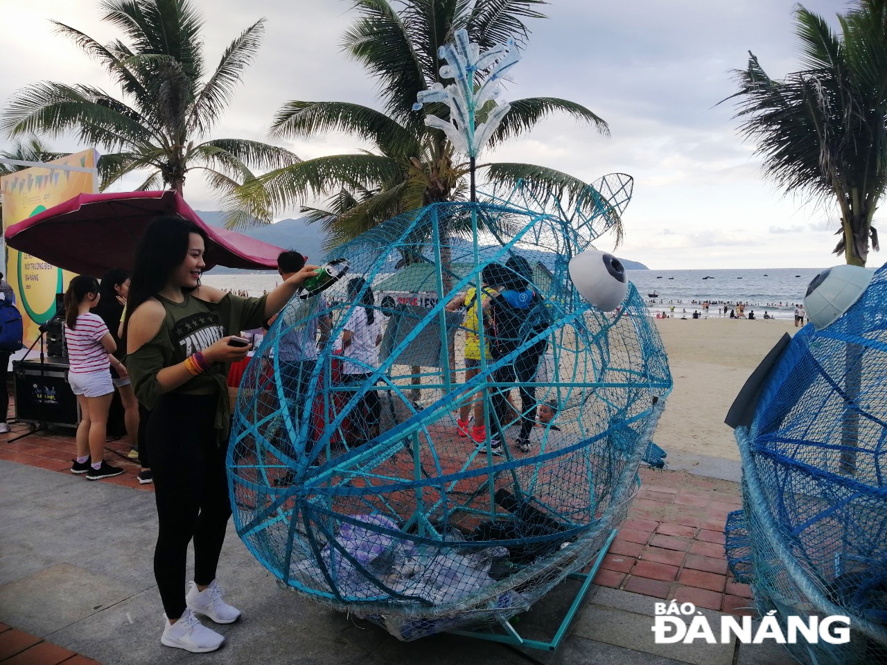 Many locals and visitors are seen showing their interest in creative sculptures featuring gobies swallowing plastic waste