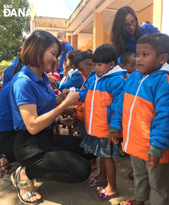 Đoàn viên Chi đoàn Cục Dự trữ Nhà nước khu vực Đà Nẵng tặng quà cho các em mầm non và học sinh tiểu học tại điểm trường Cútchrun. Ảnh: T.N