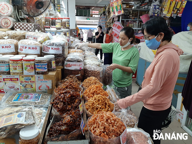 Khách mang khẩu trang khi đến mua sắm tại chợ Hàn chiều 16-3. Tuy nhiên, ghi nhận nhiều người vẫn còn chưa chủ động bảo vệ mình bằng biện pháp này. Ảnh: KHÁNH HÒA