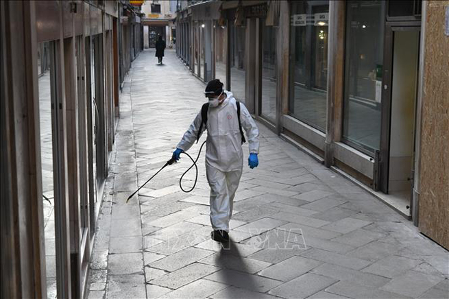 Phun thuốc khử trùng phòng lây nhiễm Covid-19 tại Venice, Italy, ngày 11-3. Ảnh: AFP/TTXVN
