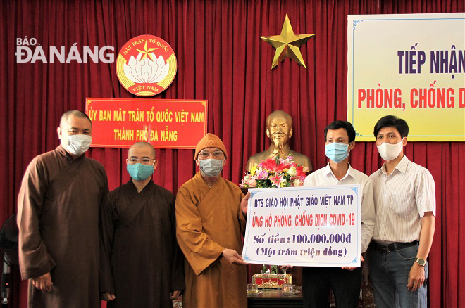 Phó Chủ tịch Ủy ban MTTQ Việt Nam thành phố Lê Văn Minh tiếp nhận ủng hộ từ Ban Trị sự Giáo hội Phật giáo Việt Nam thành phố. Ảnh: L.P