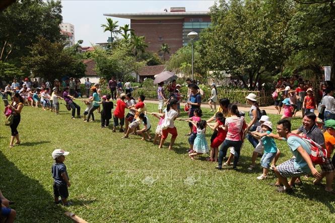 Cả gia đình cùng tham gia kéo co - một trò chơi dân gian mang đậm tính đoàn kết tại Bảo tàng dân tộc học Việt Nam (2014) . Ảnh: Anh Tuấn/TTXVN