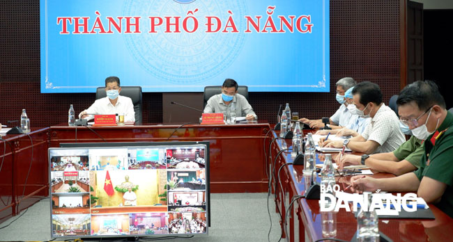 Phó Bí thư Thường trực Nguyễn Văn Quảng (trái) và Phó Chủ tịch UBND thành phố Lê Trung Chinh chủ trì phiên họp trực tuyến tại điểm cầu Đà Nẵng. Ảnh: PHAN CHUNG