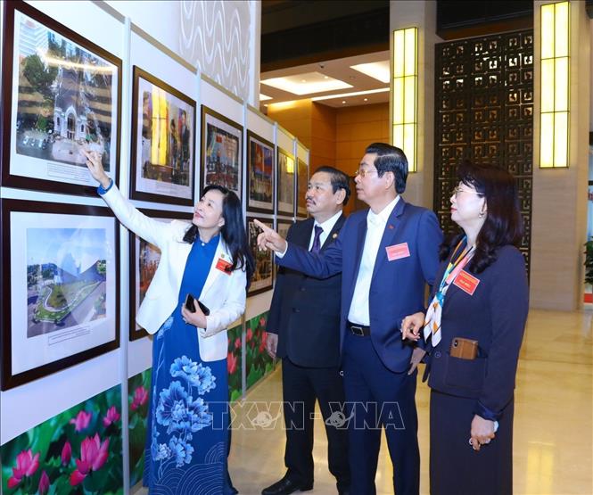 Các đại biểu tham quan triển lãm ảnh tại hội nghị. 