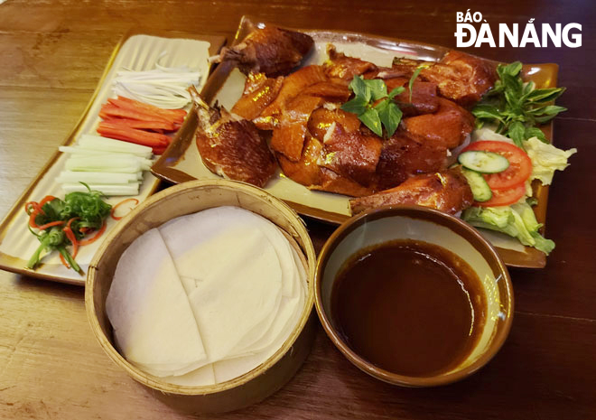 Peking duck with the shiny brown skin enveloping the soft and pungent meat