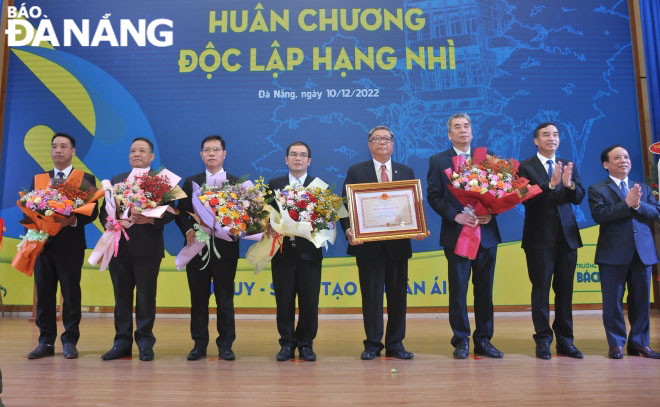 Chủ tịch UBND thành phố Lê Trung Chinh (thứ hai từ phải sang) và PGS.TS Nguyễn Ngọc Vũ (thứ nhất từ phải sang) chúc mừng nhà trường. Ảnh: NGỌC HÀ