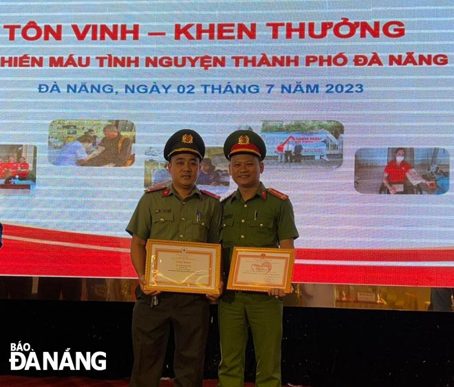 Trung úy Trương Đình Việt (bên trái) nhận Bằng khen tại Lễ Tôn vinh - Khen thưởng hiến máu tình nguyện năm 2023 