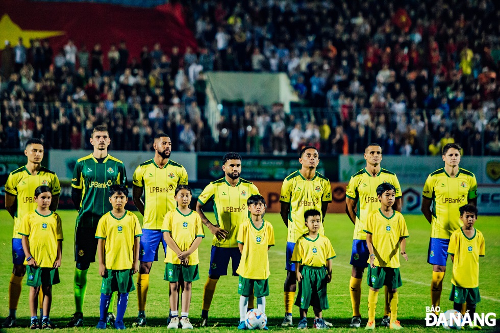 Brazilian players sing the national anthem at the Hoa Xuan Stadium