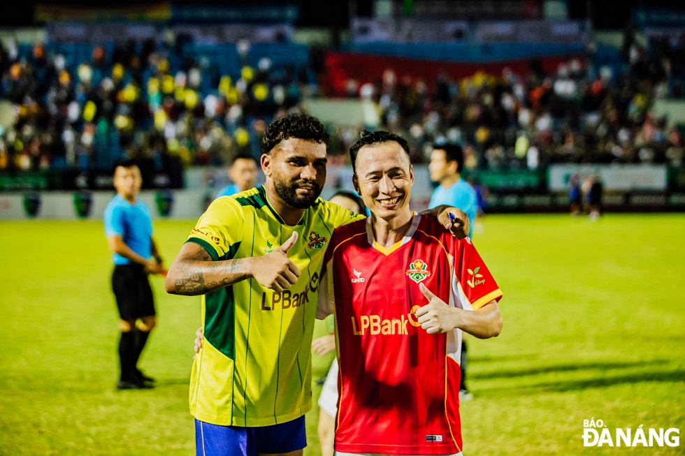 Vietnamese and Brazilian players take souvenir photos after the match.